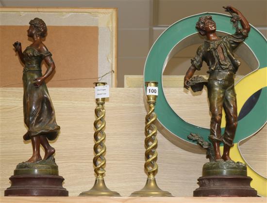 A pair of Spelter figures, signed Rousseau and a pair of brass candlesticks tallest 50cm